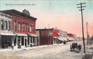 A vintage postcard showing downtown Marceline. A horse and cart are in the foreground and several shops are behind it.
