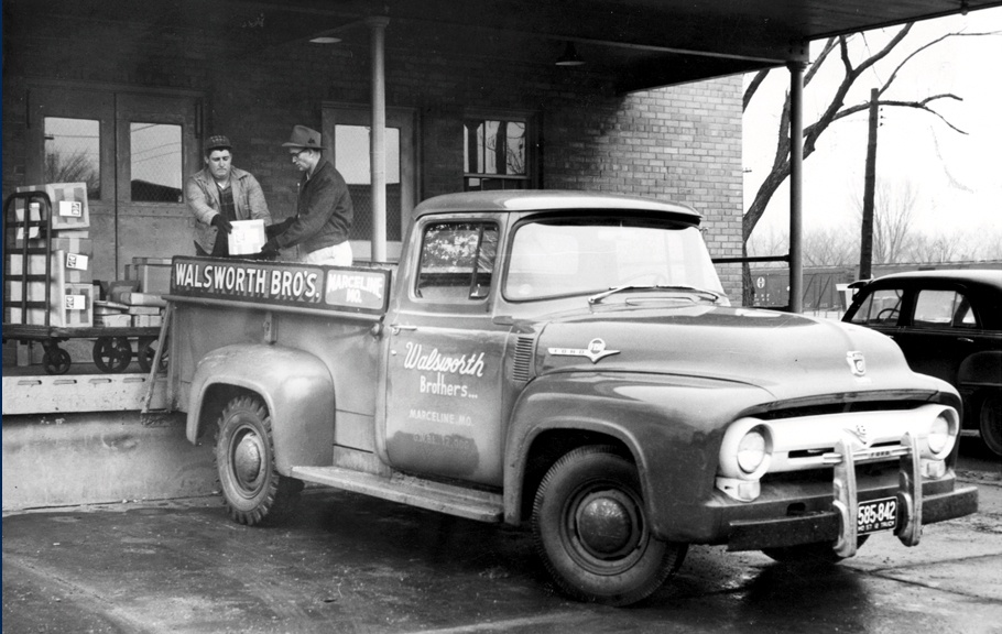 A black and white photo of an antique truck with "Walsworth" on the side.