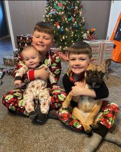Angie Warner's grandchildren in Christmas pajamas with puppy