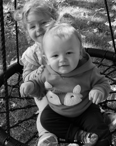 Angie Warner's grandchildren sitting on swing