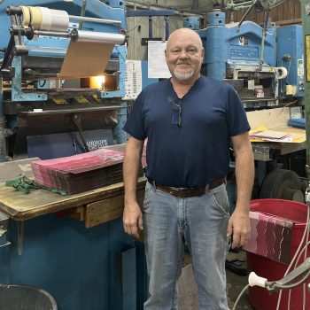 Darryl Niemeier standing in front of finishing machinery