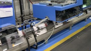 image of blue and yellow printing press running