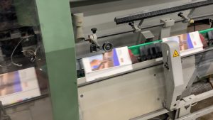 Publication on saddle stitcher before the spine is stitched