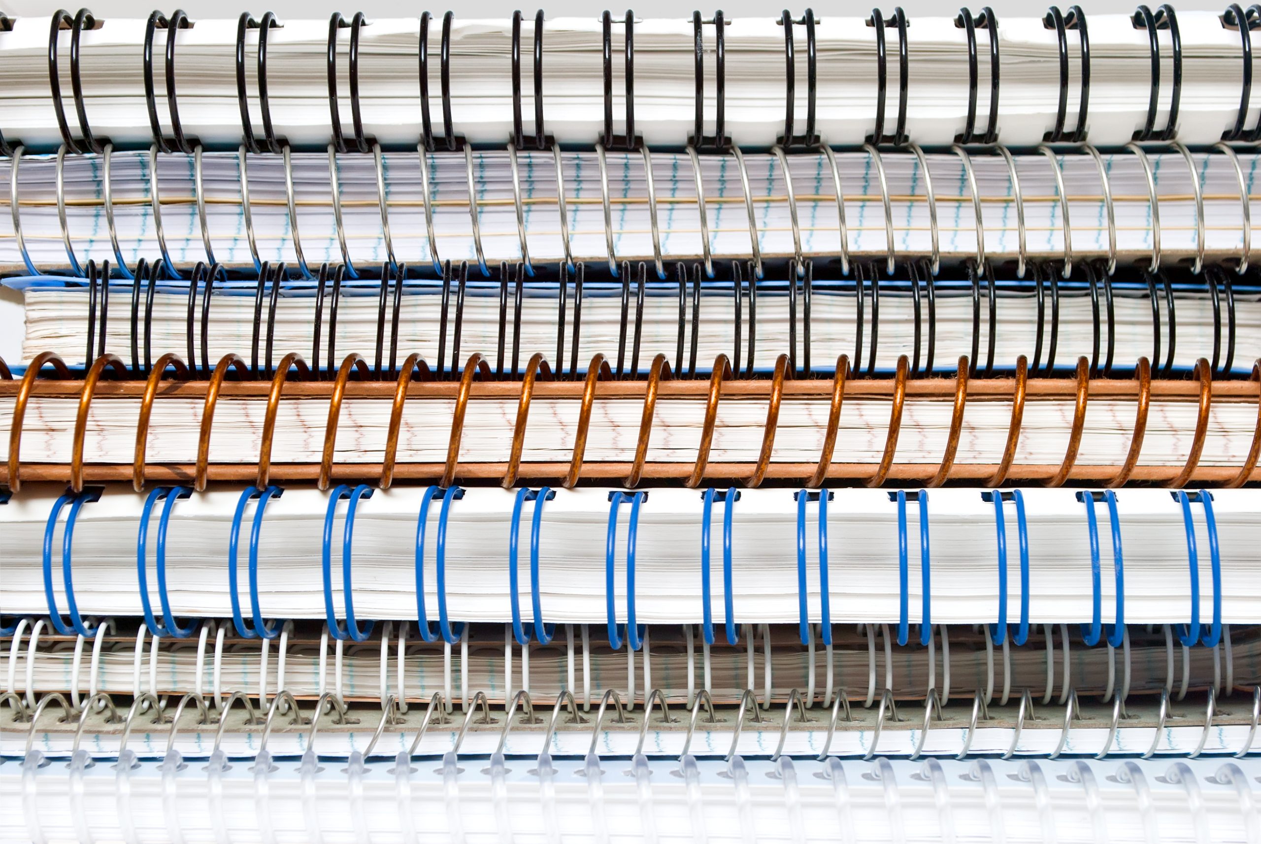 Stack of mechanically bound notebooks