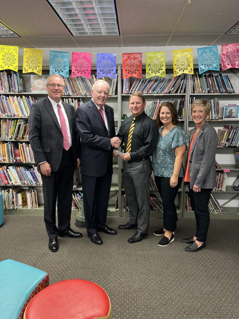 Don O. Walsworth and Jeff Vogel present a $2,500 check to Dr. Zach Bruner, Amy Sportsman and Sarah Dunham from Marceline R-V School District.