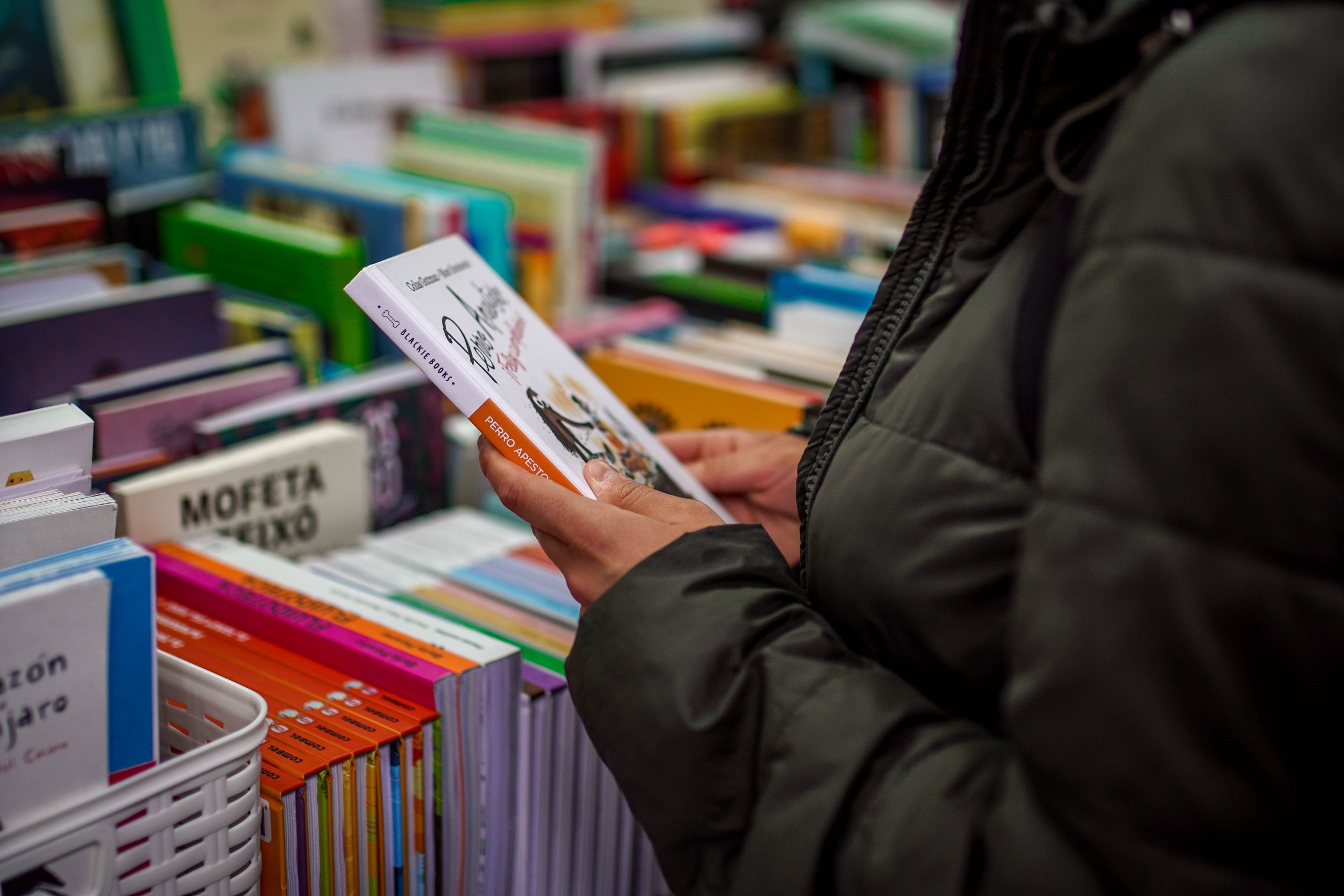 A woman carefully examining a book cover