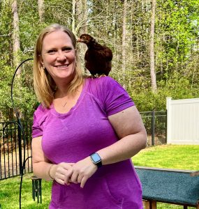 A little over a year ago, Kirsten got some chickens so here we see her posing for a photo with a chicken on her shoulder.