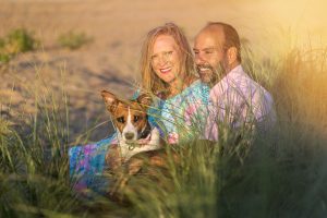 Kirsten with her boyfriend Marco and fur baby (dog) Samantha sitting at the beach