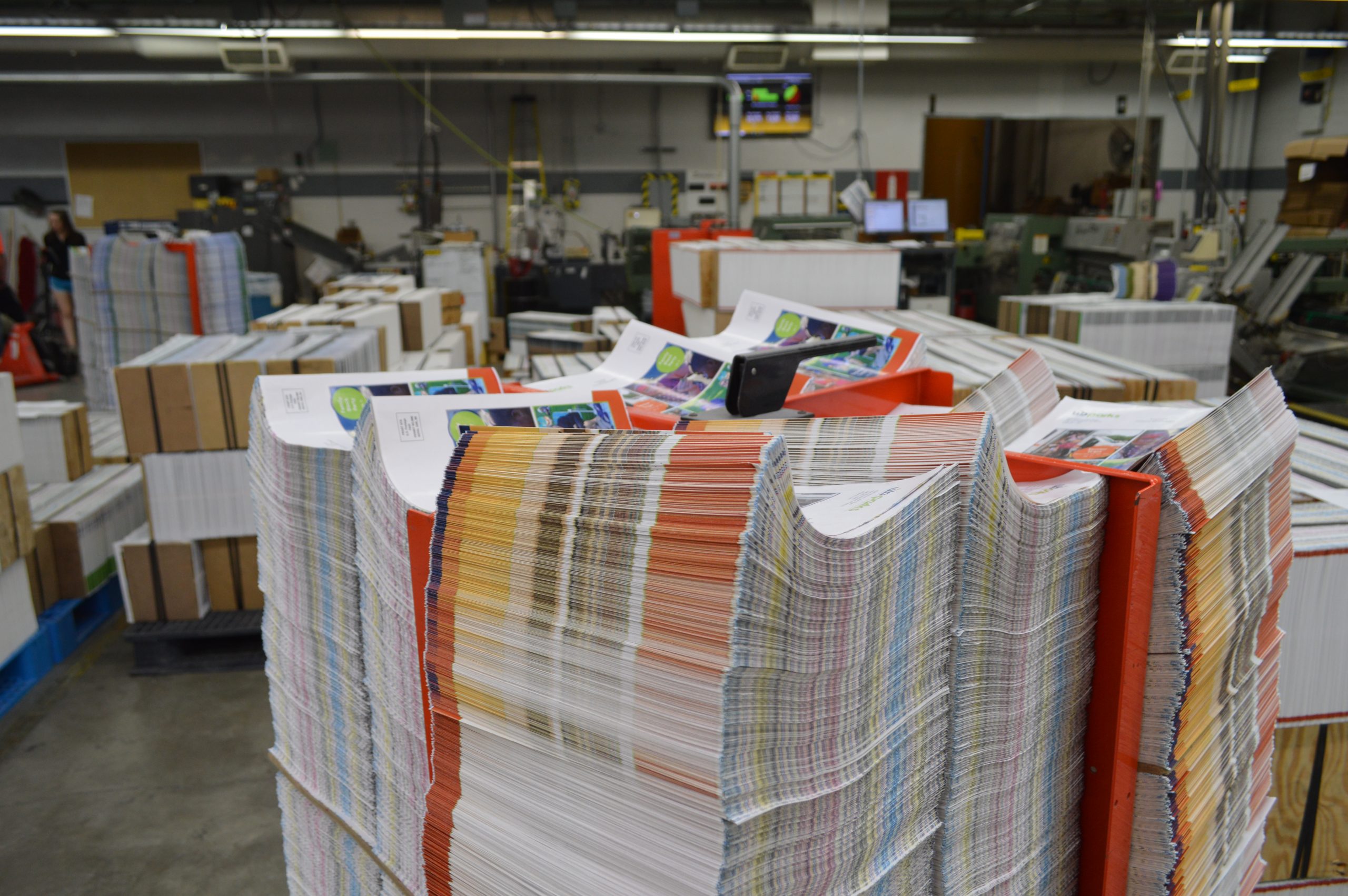 Stacks of unbound magazines in the Walsworth -- Fulton printing press