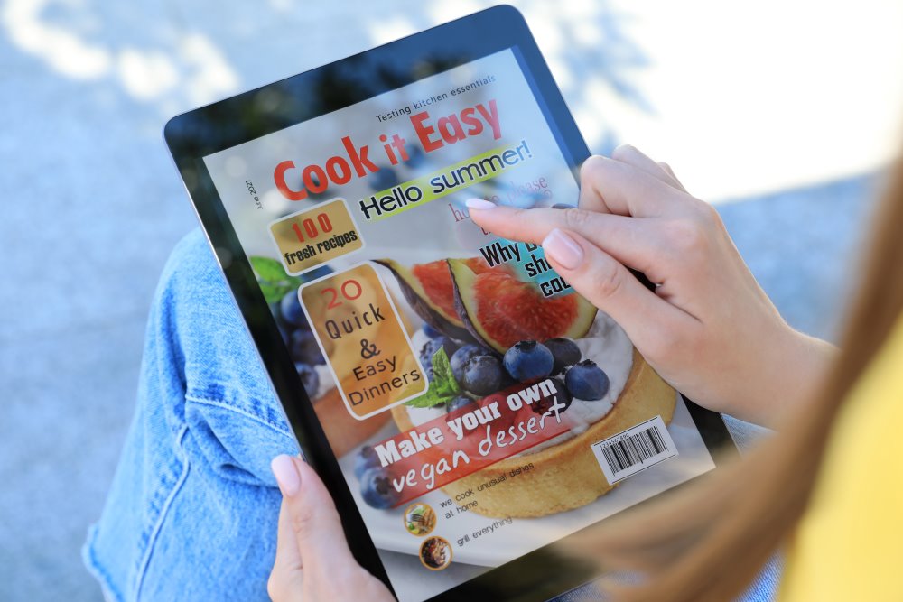 A woman reading a cooking magazine on her tablet
