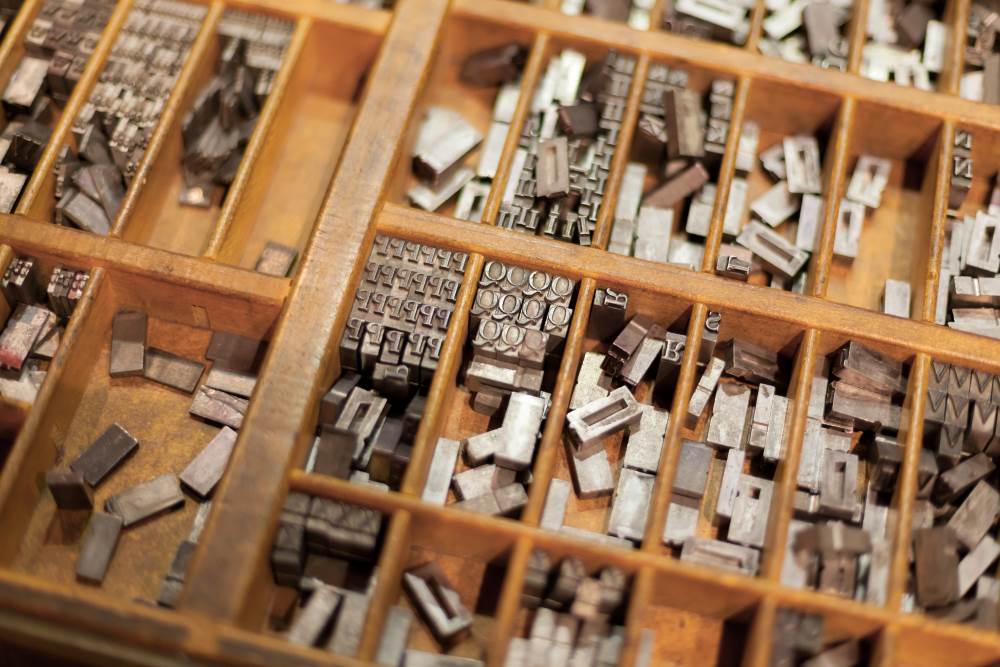 A box of old fashioned printing press plates