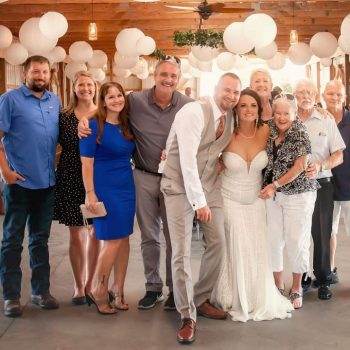 Marie Frazier with her family on her wedding day in a barn.