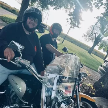 Evan on a motorcycle with his friend