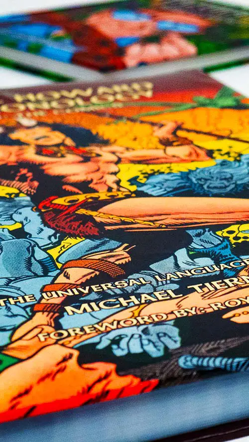 Two graphic novels laid out on a table