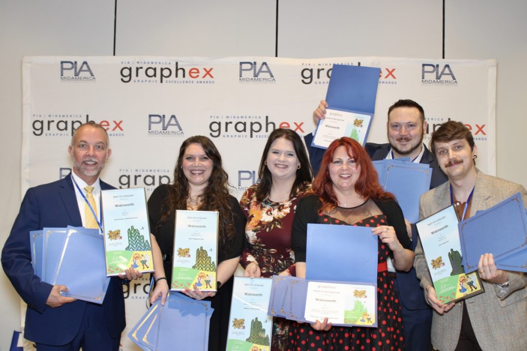 A group of Walsworth employees holding GraphEx awards