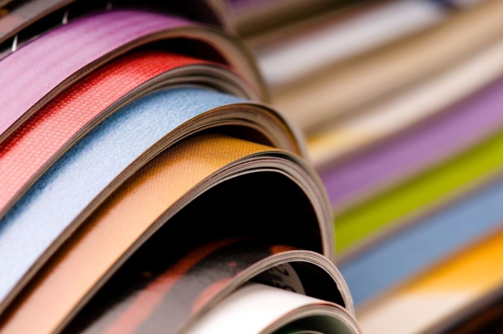 a stack of colorful coated magazines