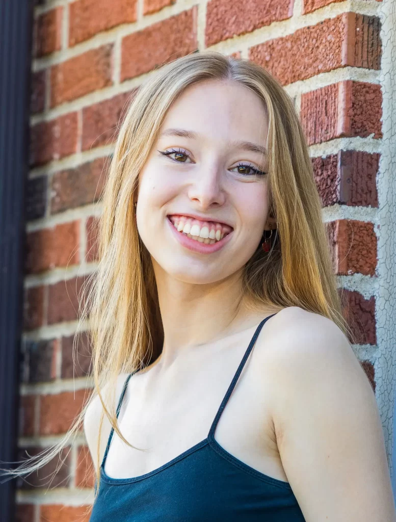 Laurel portrait photo against a brick wall