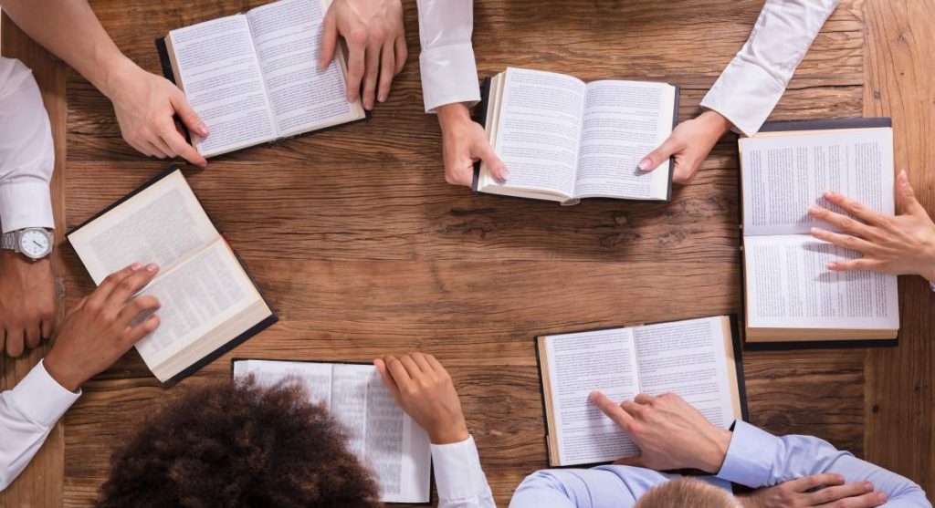 A group of religious learners studying around a table