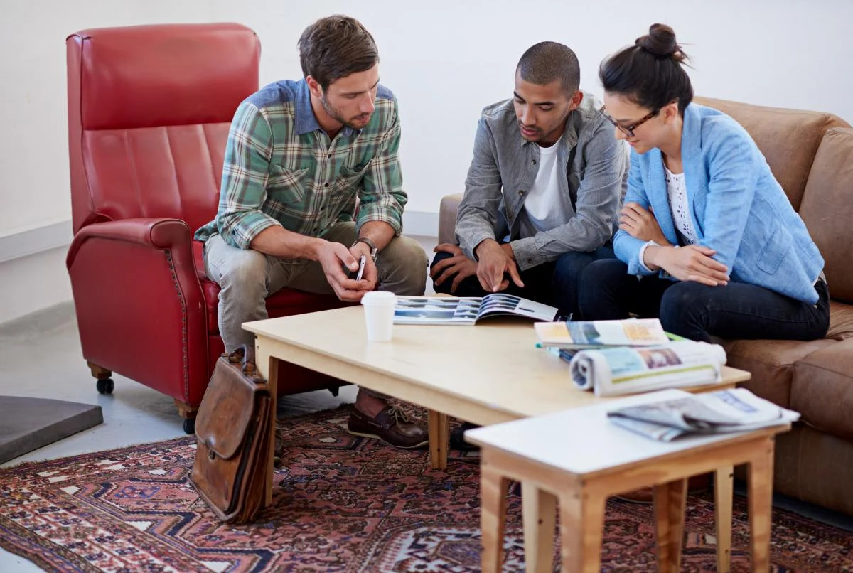 A group of coworkers browsing a catalog together