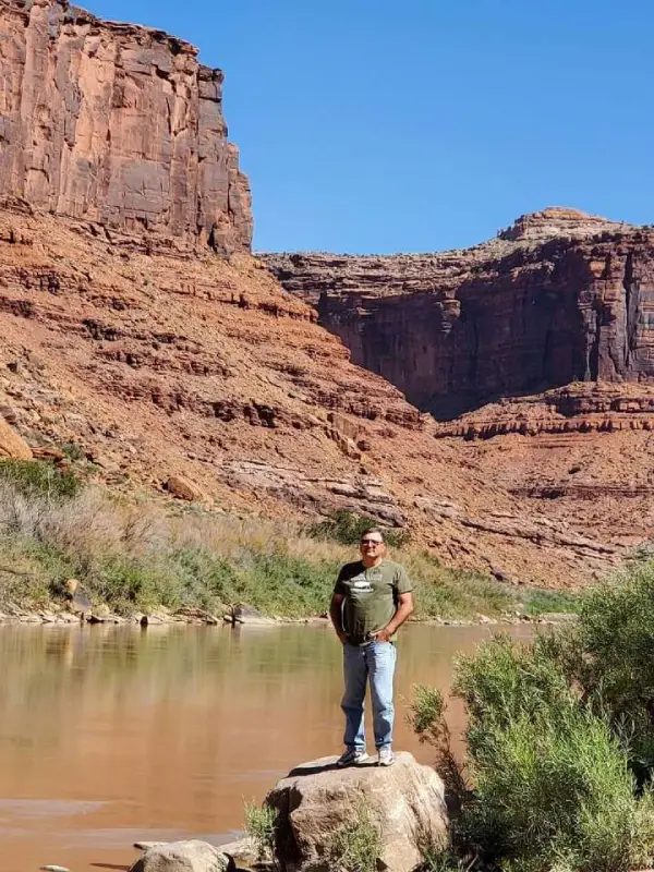 David outdoors near a canyon and river.