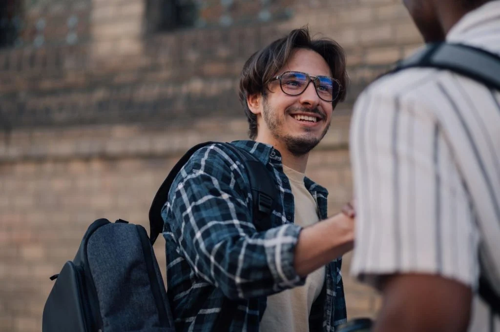 college students shaking hands
