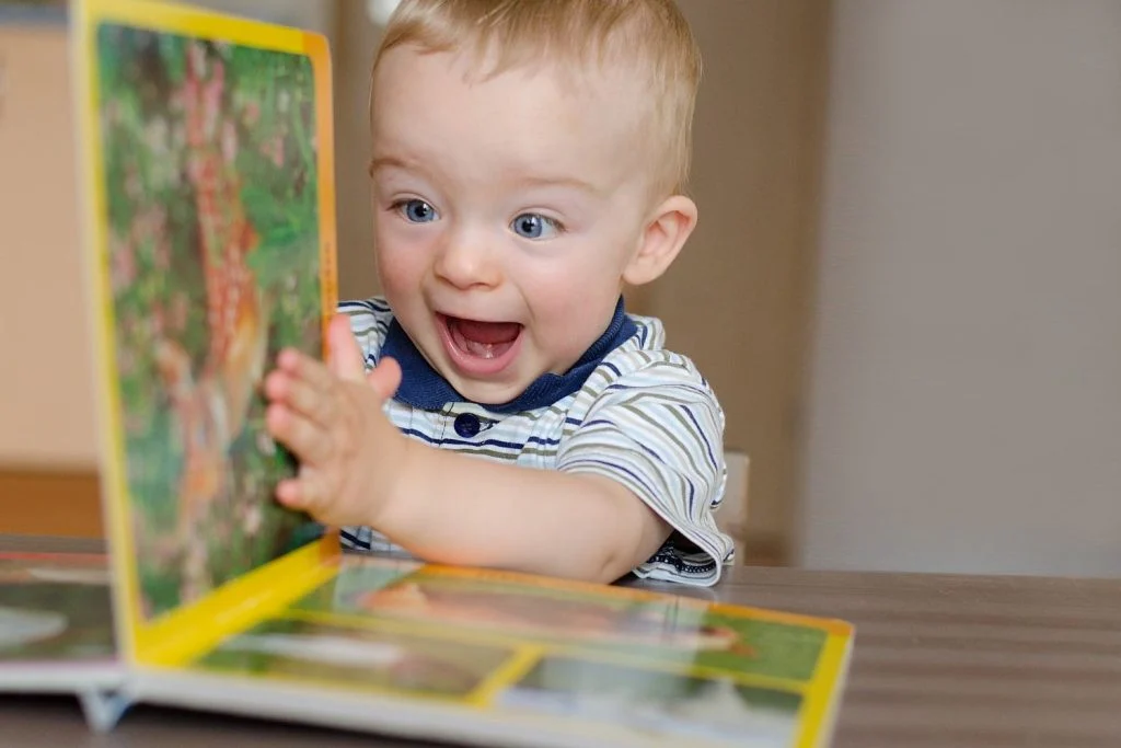 A happy child opening a book