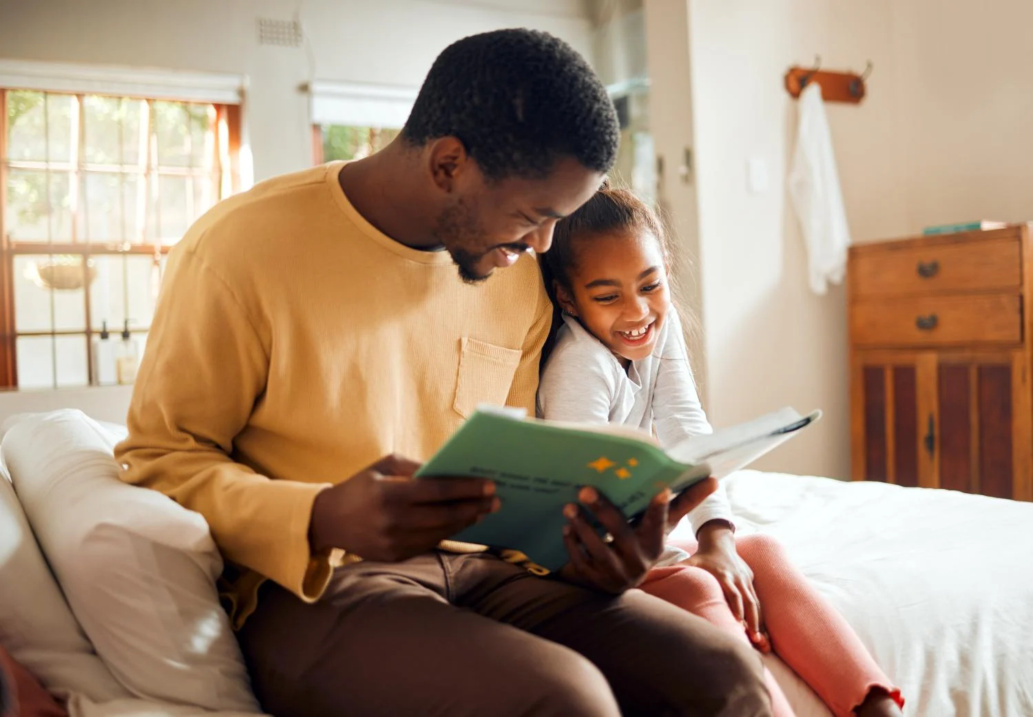 A father reading to his daughter