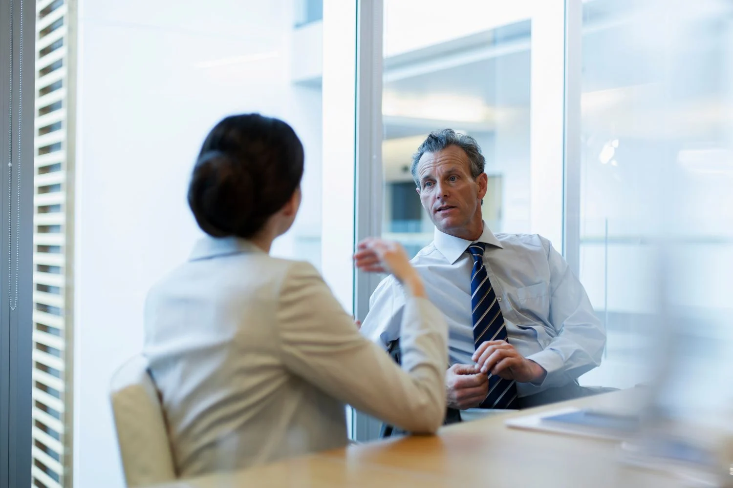 A businessman and business woman meeting at a table