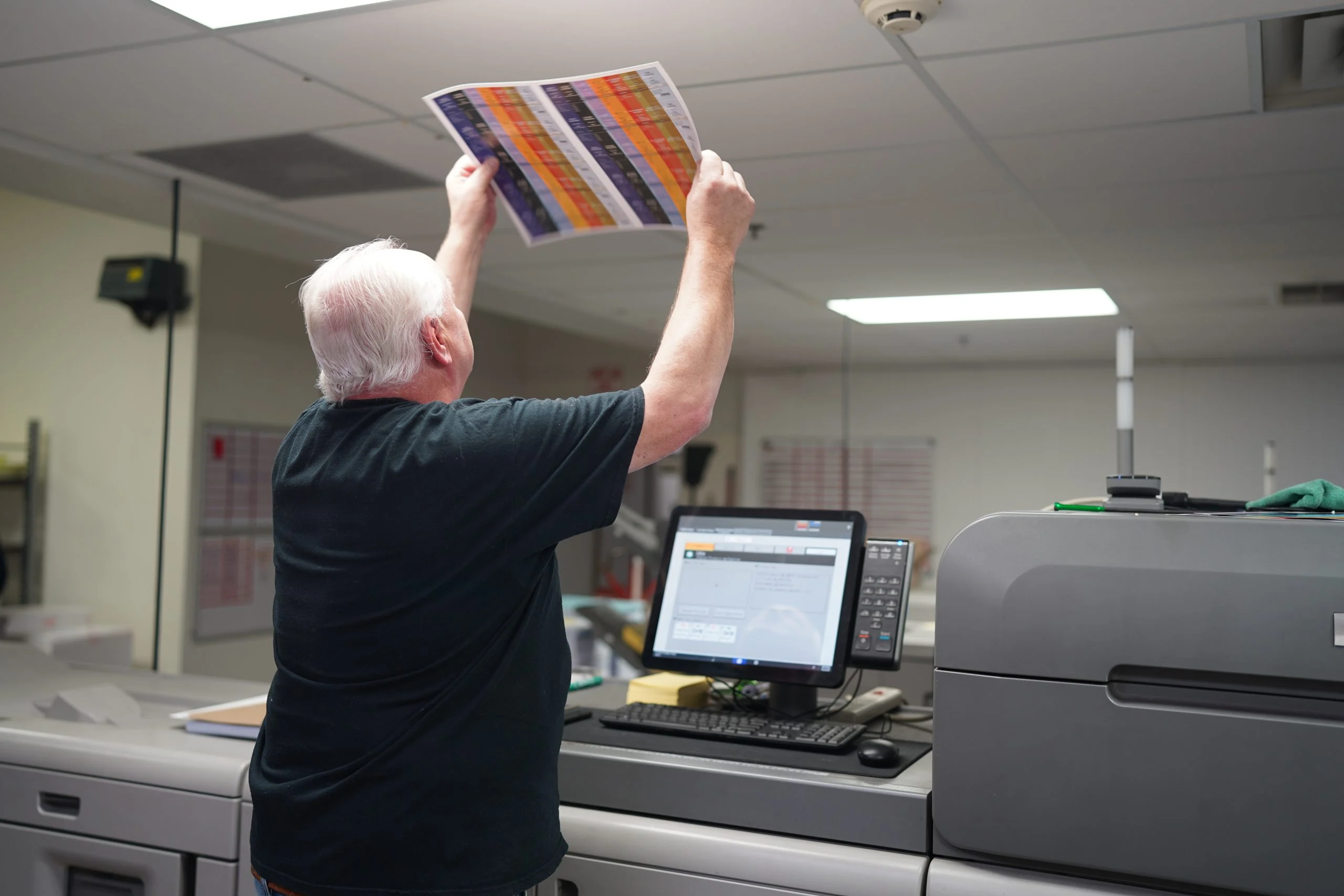 A Walsworth employee reviewing a proof